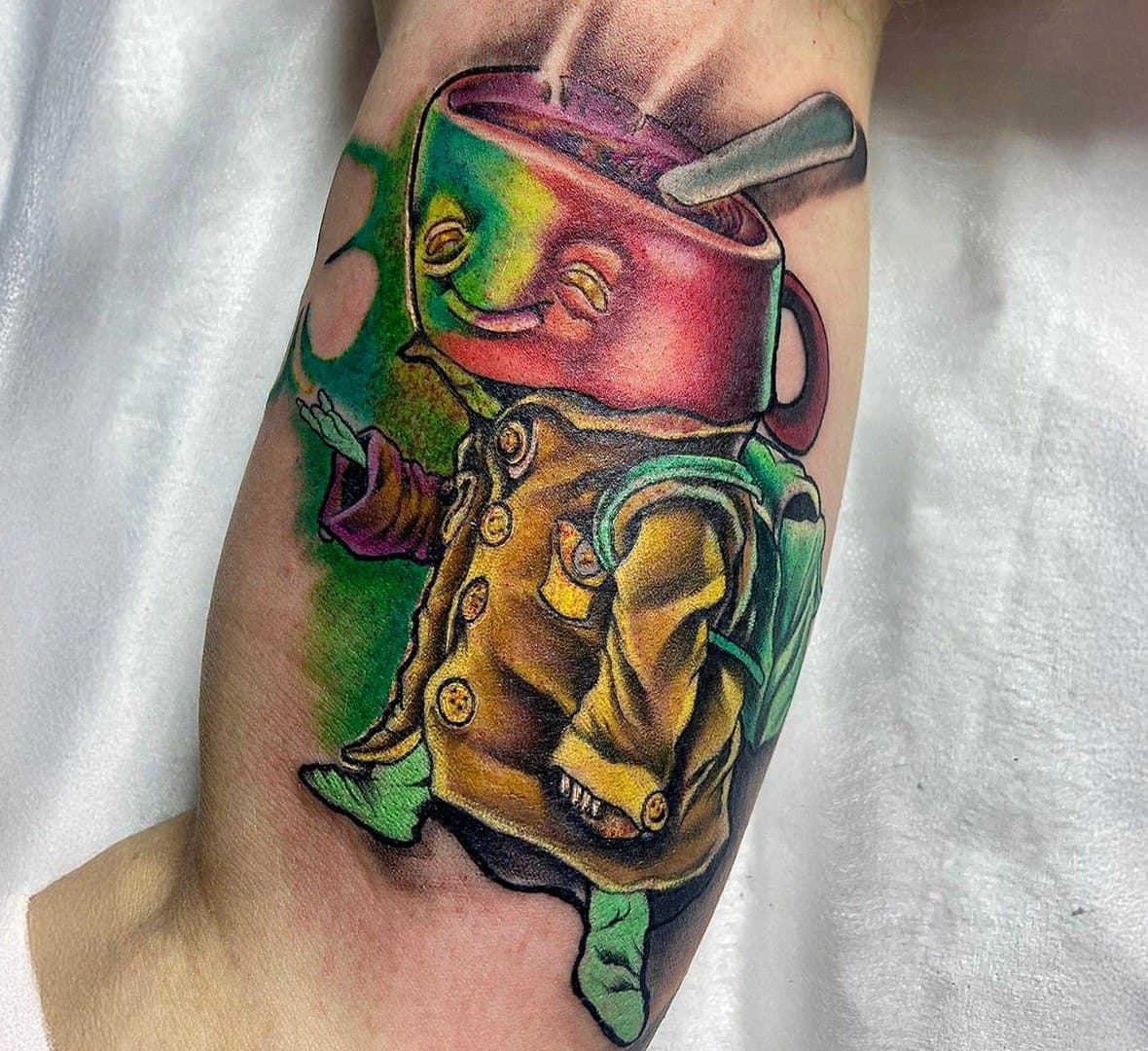 Surreal colour tattoo of a smiling teacup character in a yellow coat