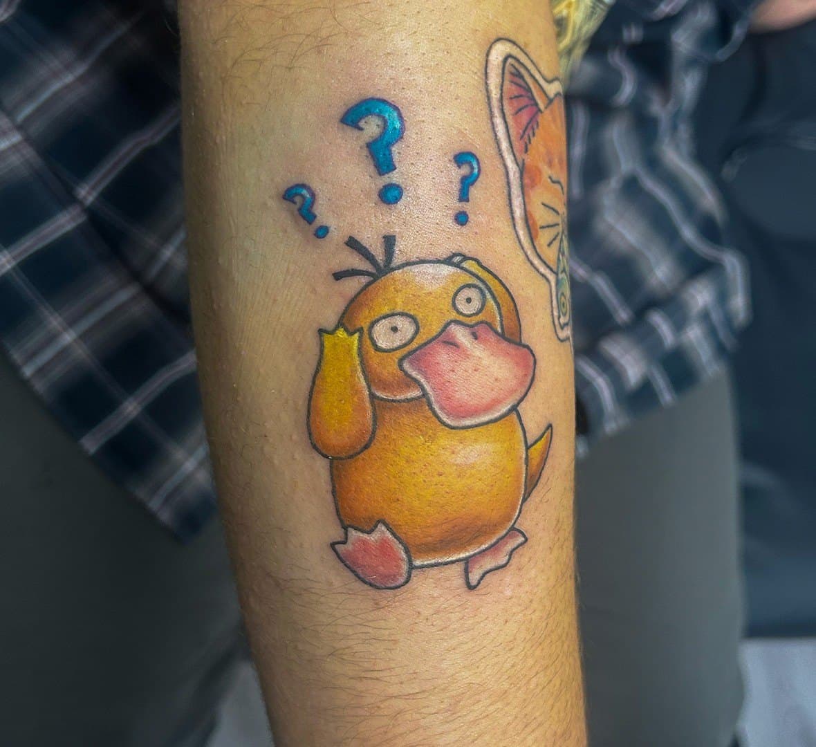 Colour cartoon tattoo of a puzzled yellow duck with question marks